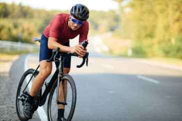 Young man feeling tired after long morning ride on road